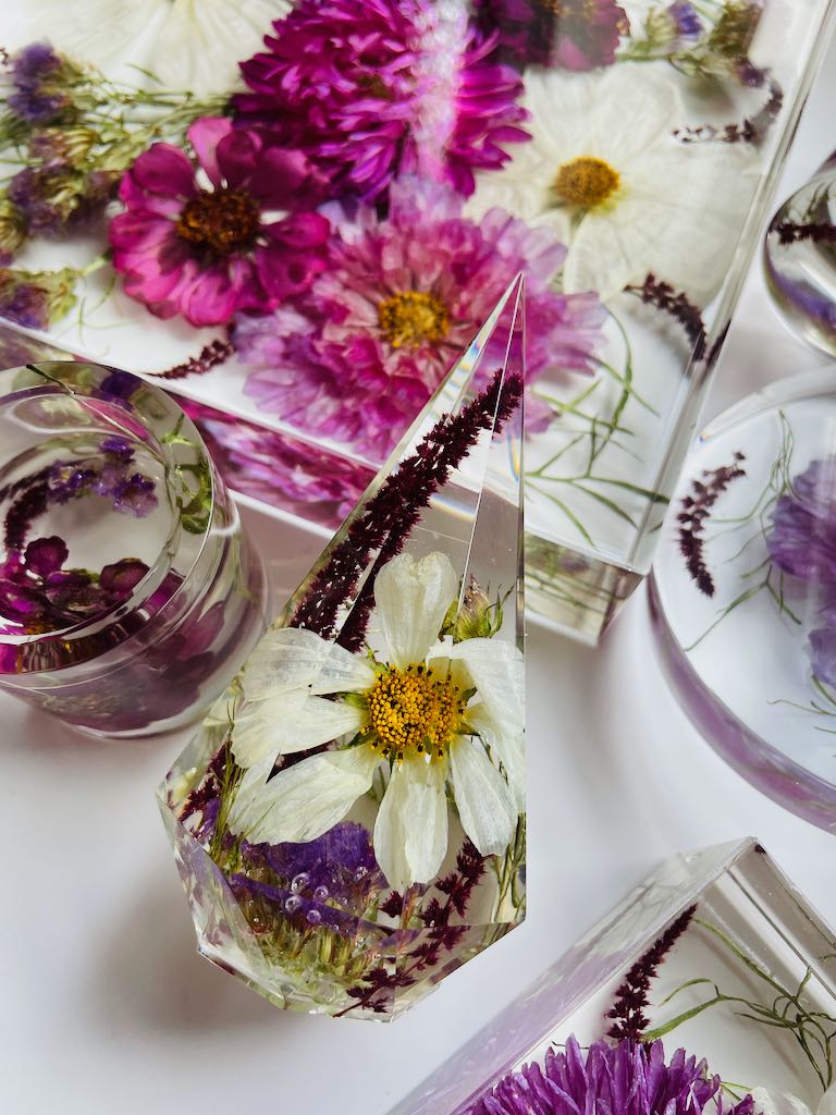 purple and white cosmo wedding flowers preserved in resin ring holder